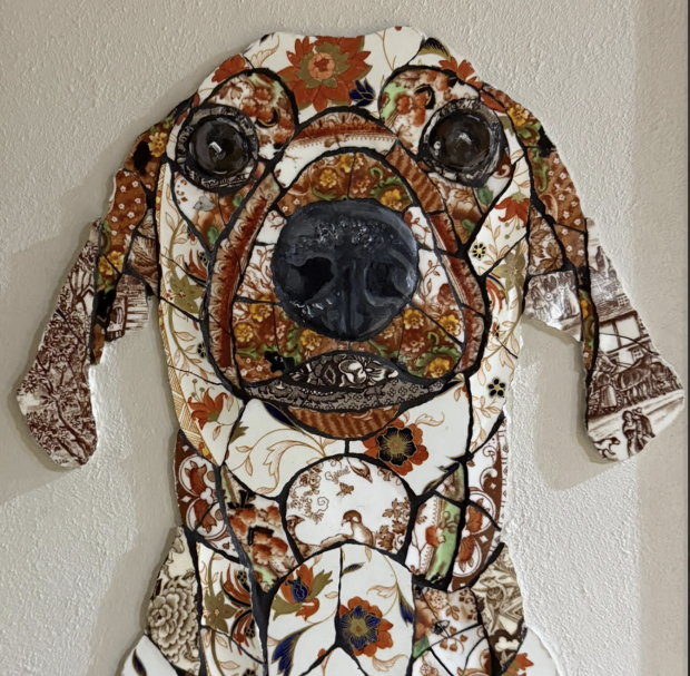 Handmade mosaic portrait of a Dachshund created from individually hand‑cut vintage china plates in soft cream and patterned tones.”