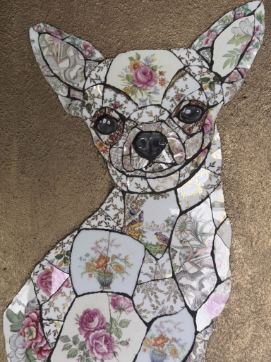 A decorative mosaic of a Chihuahua featuring floral patterns and fine detailing.