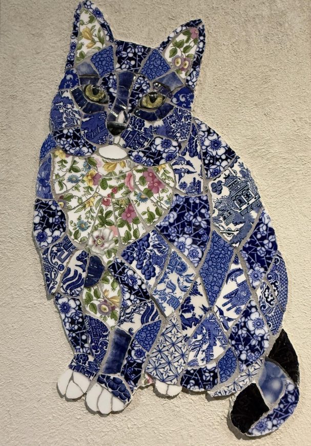 Handmade mosaic portrait of a black and white cat created from individually hand‑cut vintage china plates in blue and patterned tones.”