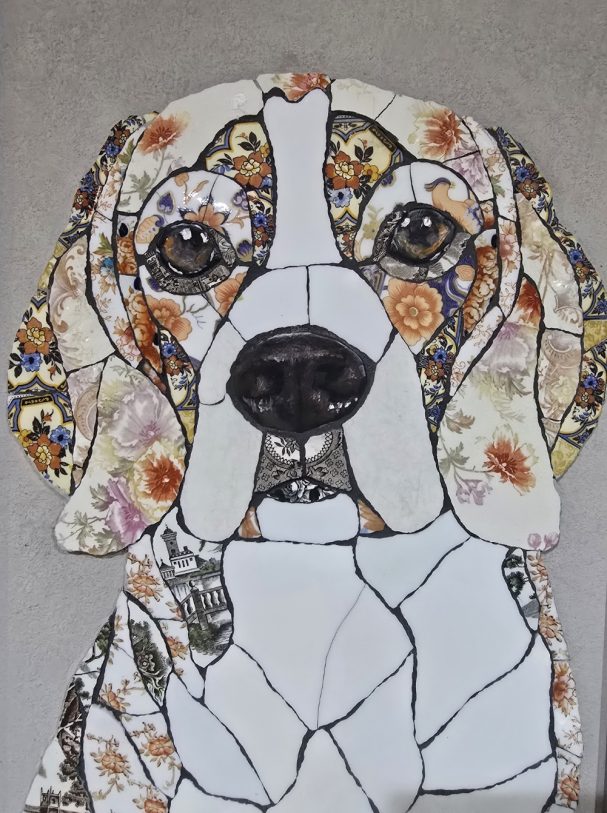 “Handmade mosaic portrait of a Beagle created from hand‑cut vintage china plates, featuring warm pink and floral tones.”