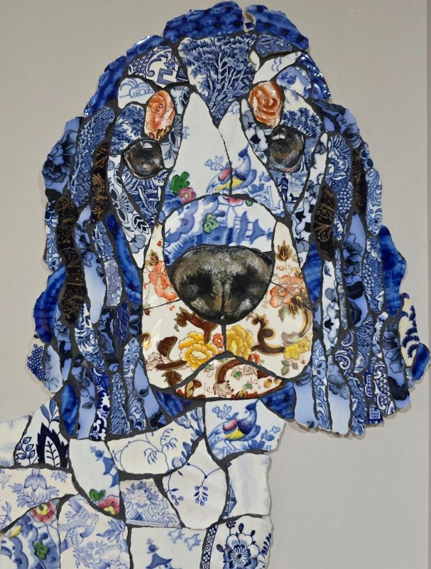 “Handmade mosaic portrait of a Cocker Spaniel created from individually hand‑cut vintage china plates in dark and neutral tones.”