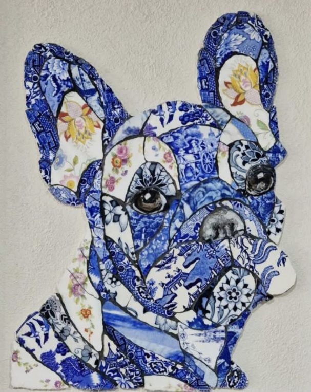 “Handmade mosaic portrait of a French Bulldog created from individually hand‑cut vintage china plates in soft cream and patterned tones.”