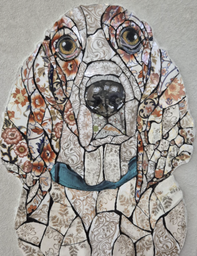 Mosaic artwork depicting a dog’s face with intricate patterns and textures.