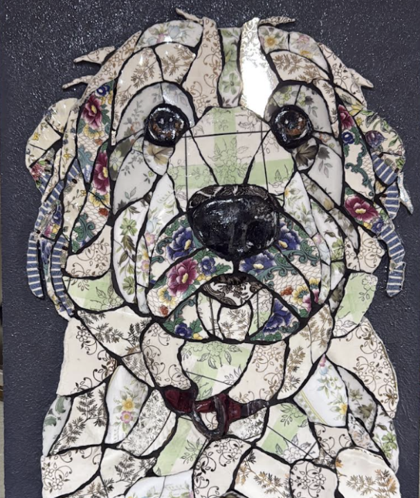 Handmade mosaic portrait of a dog created from individually hand‑cut vintage china plates in dark and neutral tones.”